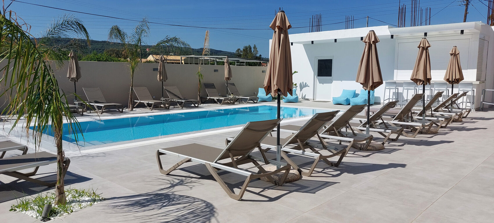 Sun loungers and parasols around the swimming pool