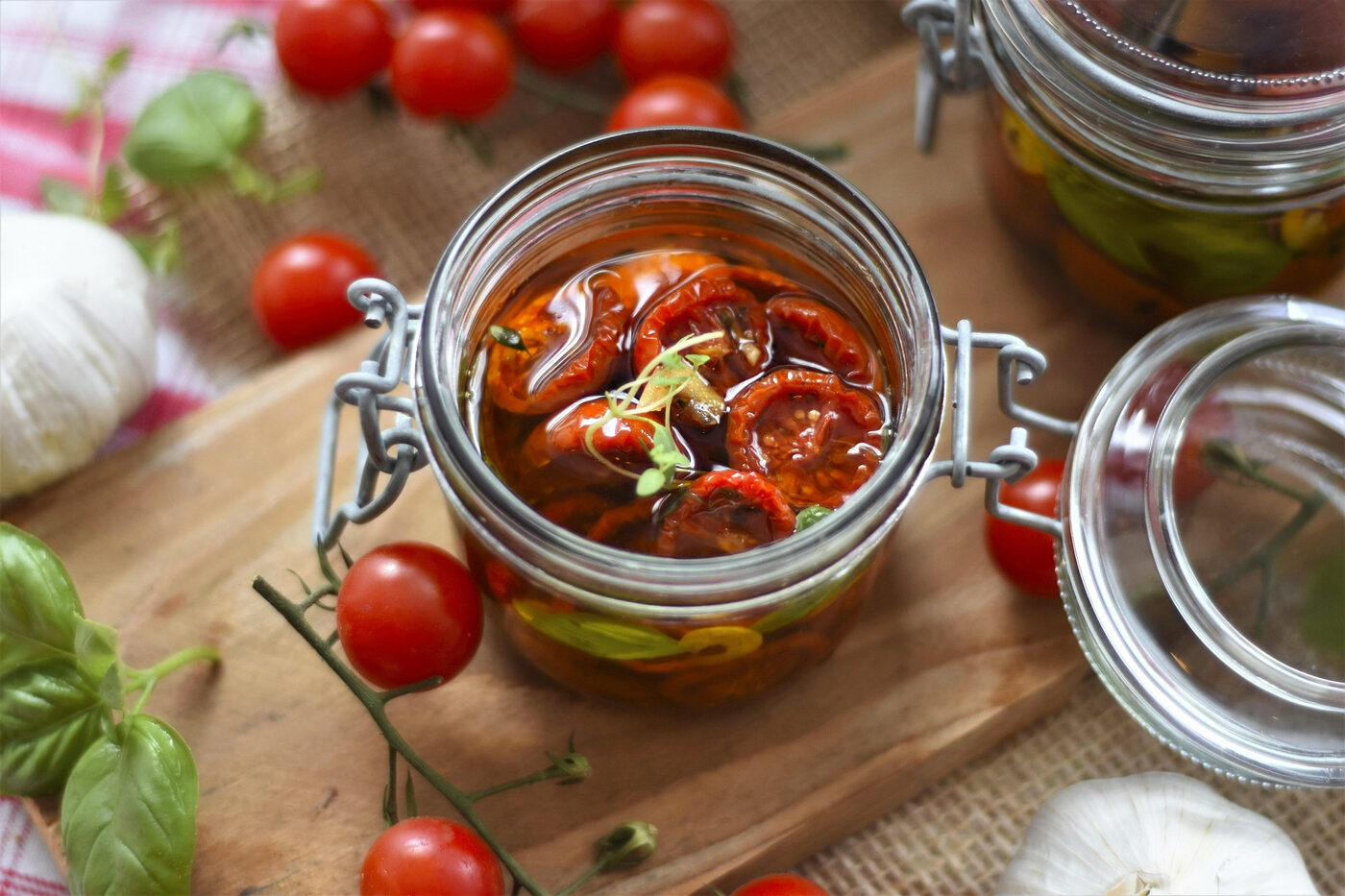 Preserved tomatoes and herbs in a jar