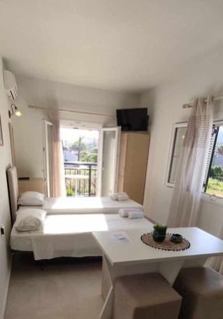 A bright room with the balcony doors open