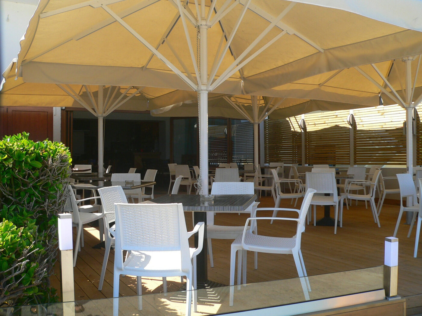 White chairs and canvas parasols on the terrace